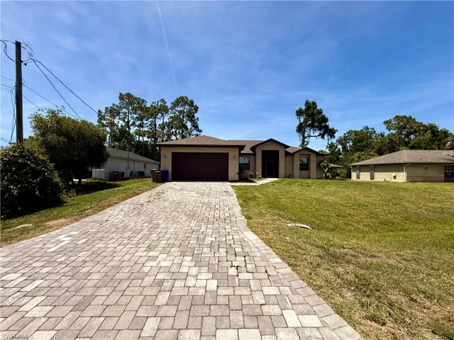 Single-story residence featuring a two-car garage and a paved driveway