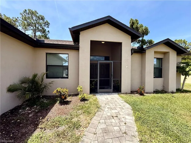 Modern exterior featuring a prominent screened entryway