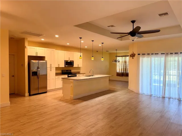 Expansive open-concept living area featuring wood-look tile flooring
