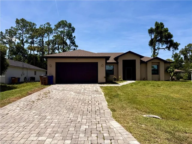 Contemporary stucco exterior with a brown shingle roof