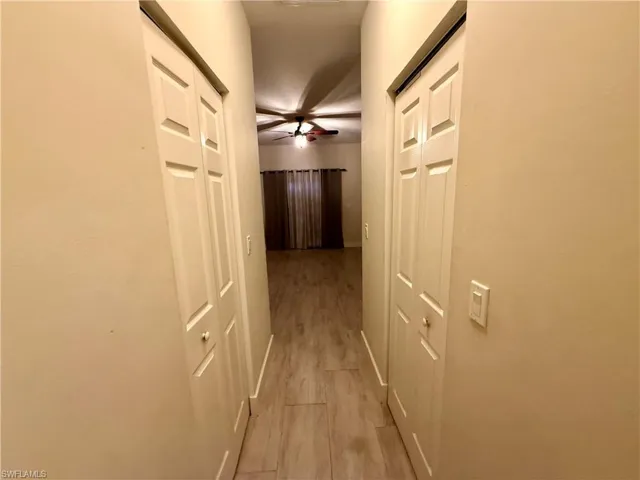 Hallway featuring light wood-finish flooring and neutral wall tones