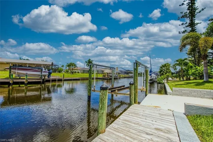Dock with boat lift and a water view