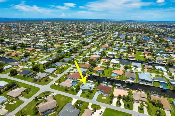 Aerial perspective of suburban area with a large body of water