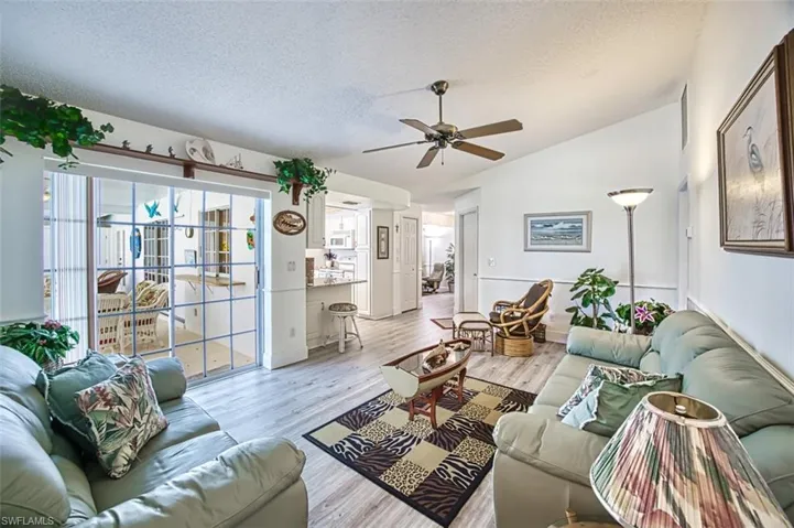 Living room featuring light wood-style floors and a ceiling fan