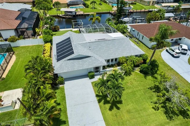 Aerial perspective of suburban area featuring a large body of water