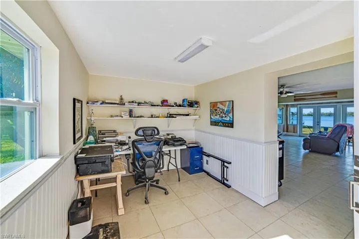 Tiled home office featuring french doors
