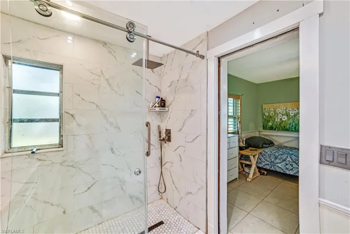 Bathroom featuring walk in shower and a wealth of natural light