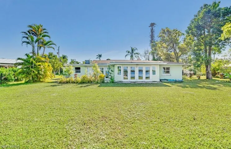Back of property with a lawn