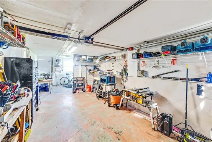 Garage with a garage door opener and a workshop area
