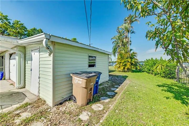 View of side of home featuring a lawn