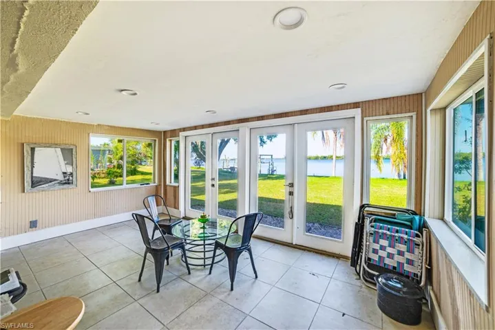 Sunroom featuring french doors and a healthy amount of sunlight