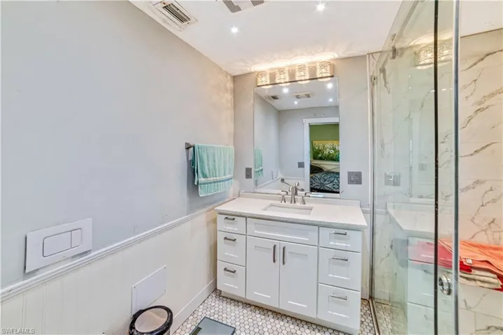 Bathroom with an enclosed shower and vanity