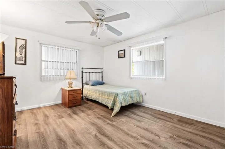 Bedroom featuring a ceiling fan and light wood-type flooring