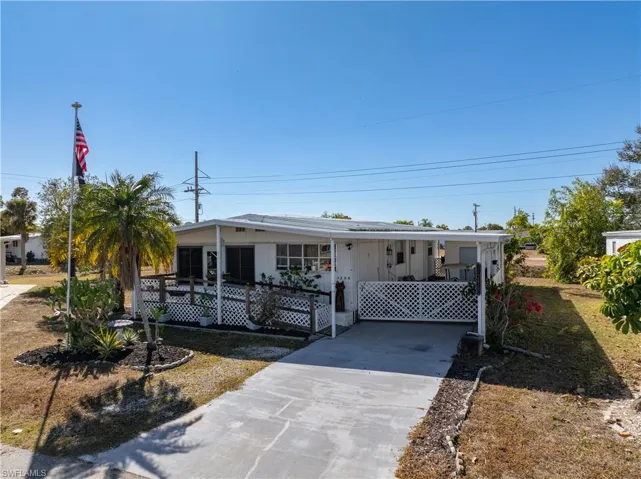 View of front facade featuring driveway and an attached carport