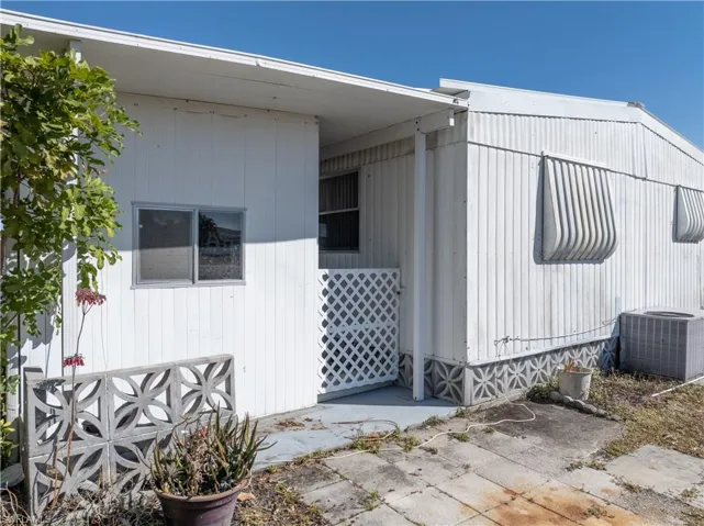 View of side of home featuring a central AC unit