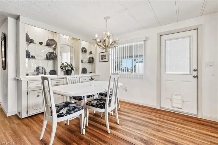 Dining room with a chandelier and light wood-type flooring