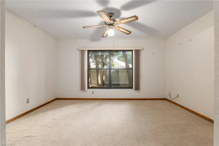 Spare room featuring carpet floors and ceiling fan