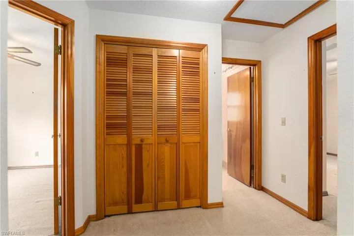 Unfurnished bedroom with light colored carpet