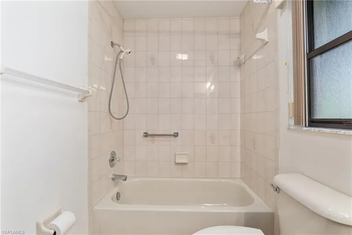 Bathroom featuring toilet and tiled shower / bath