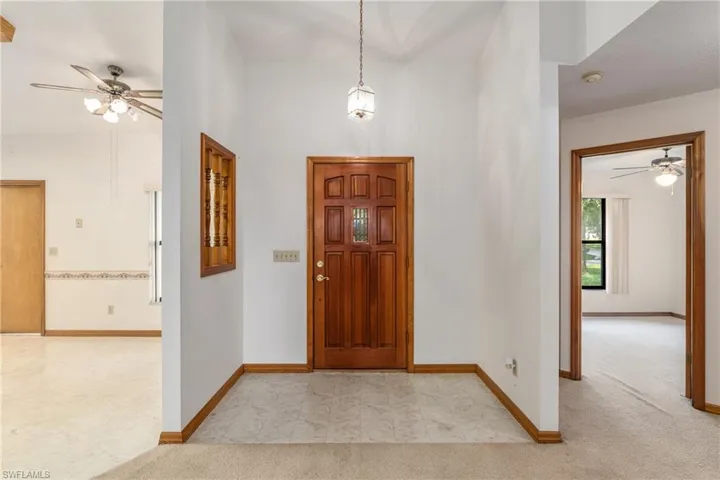 Entryway with light tile patterned flooring and ceiling fan