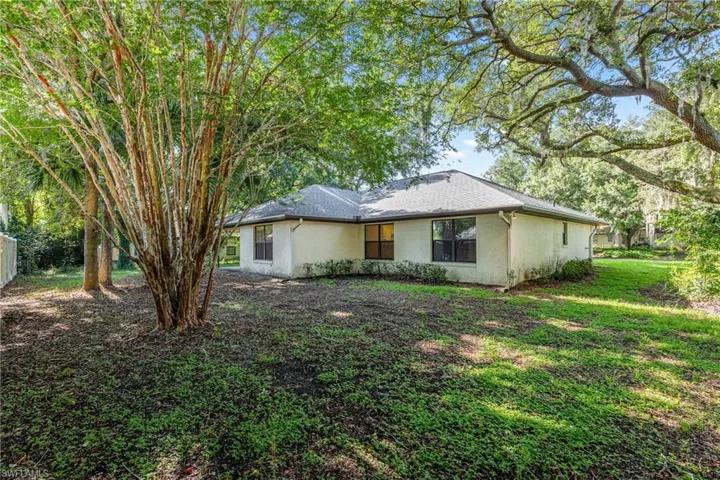 Rear view of house with a lawn