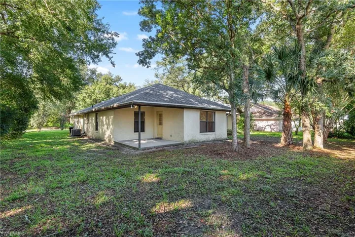 Rear view of property with a patio area and a yard