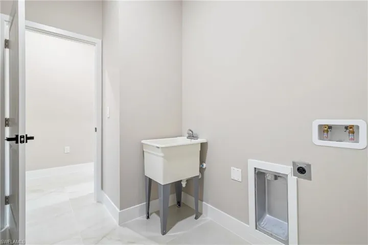 Laundry room with hookup for a washing machine and hookup for an electric dryer