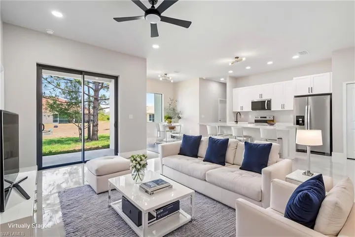Living room featuring a ceiling fan and recessed lighting