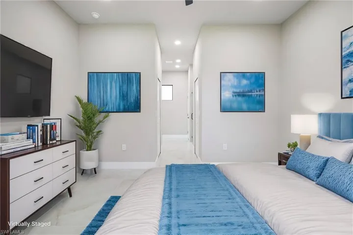 Bedroom featuring recessed lighting, a ceiling fan, and ensuite bath
