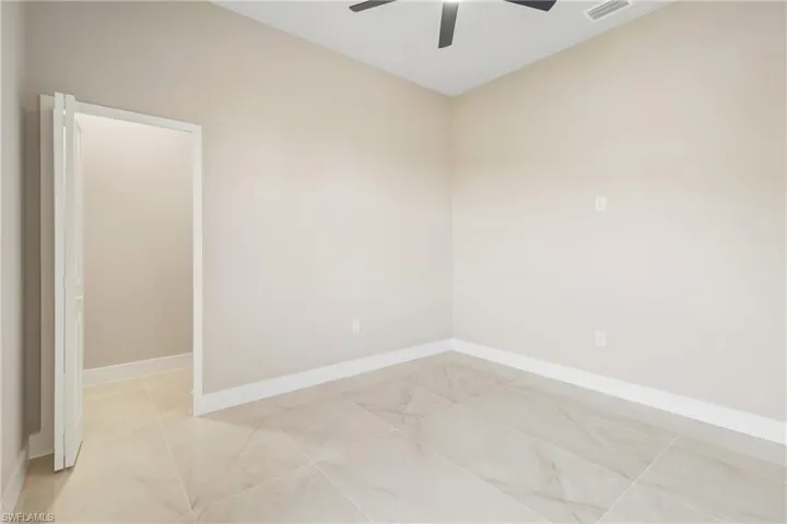 Spare room featuring baseboards and a ceiling fan
