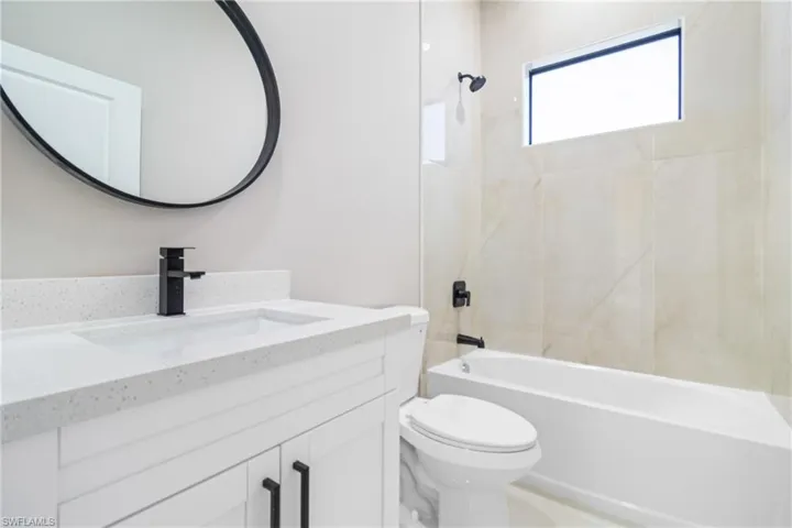 Bathroom featuring vanity and tub / shower combination