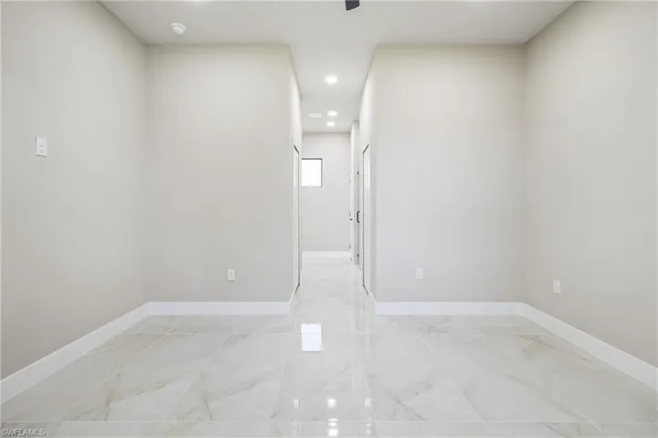 Unfurnished room featuring baseboards and recessed lighting