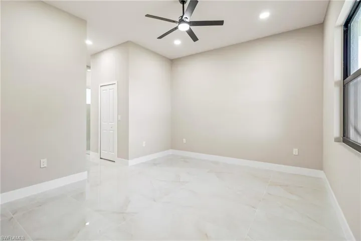 Spare room featuring ceiling fan, recessed lighting, and light marble finish flooring