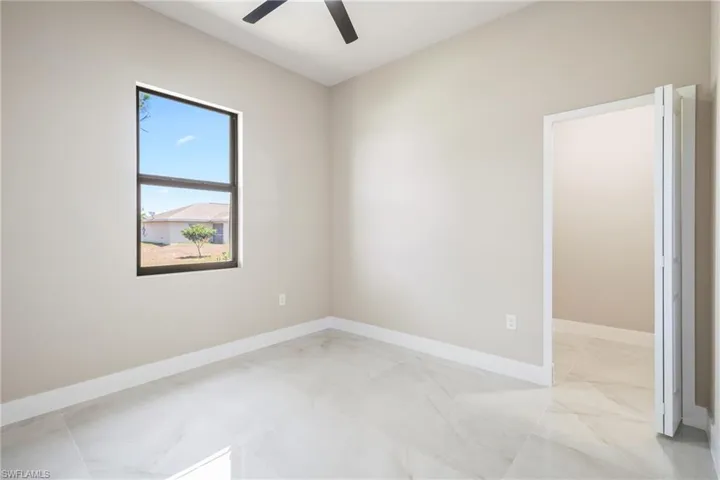 Unfurnished room with baseboards and a ceiling fan