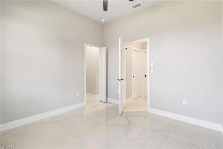 Unfurnished bedroom featuring a ceiling fan and baseboards