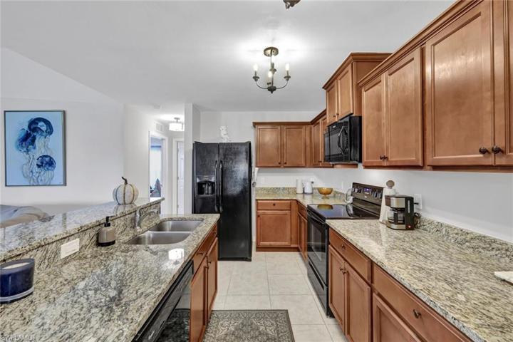 Appliances include dishwasher, glass-top stove, microwave, disposal, and new refrigerator.