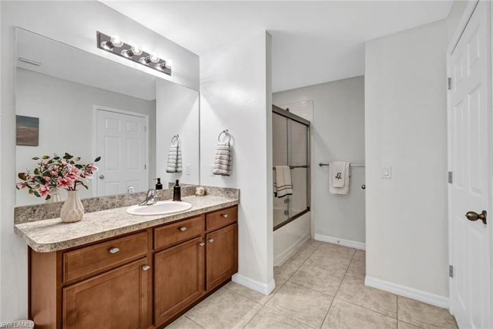 Spacious primary bathroom with tub/shower combination.