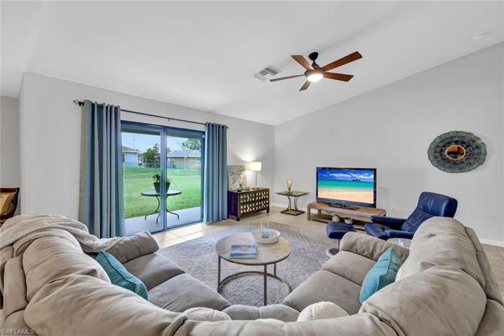 Sliding glass doors lead to the covered lanai and large back yard.