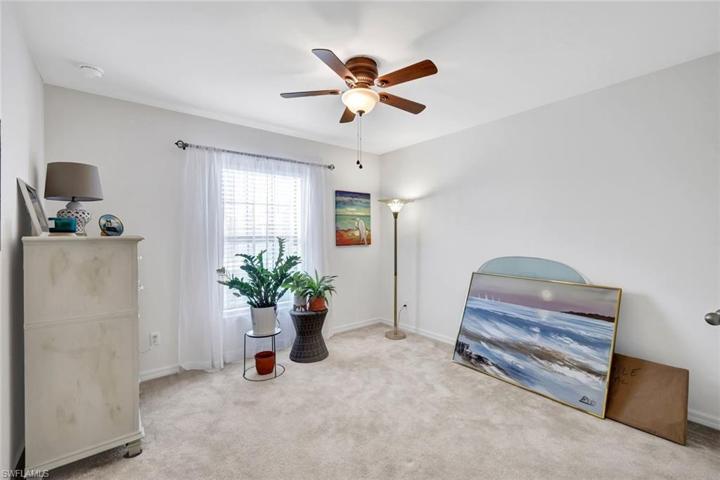 Bedroom #3. All bedrooms have neutral carpet and ceiling fans.