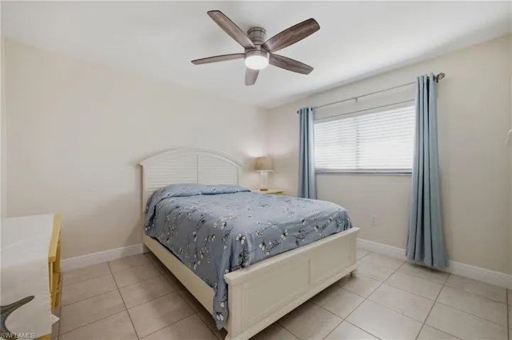 Neutral tone walls with white baseboards and tile flooring