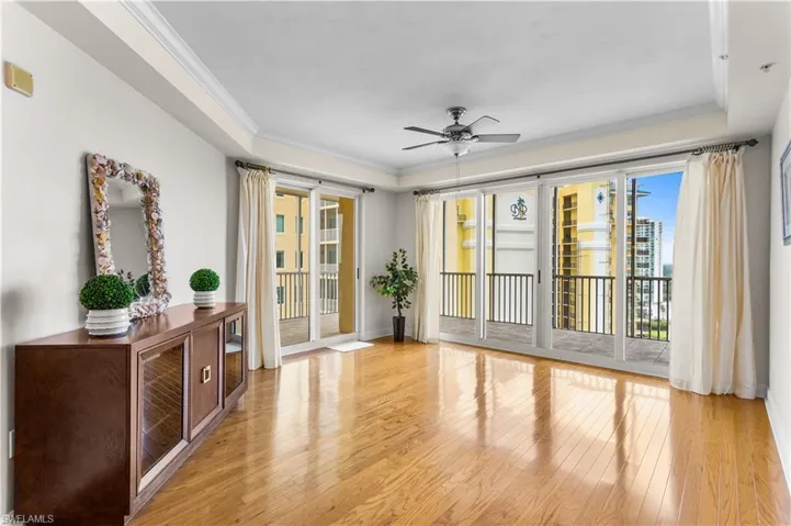 The great living room leads to a wrap-around screened balcony.