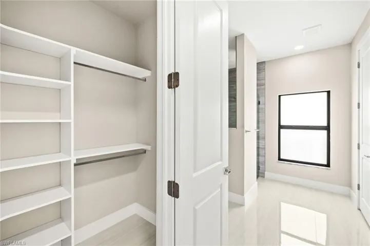 Primary bedroom closet with built in shelving (2)