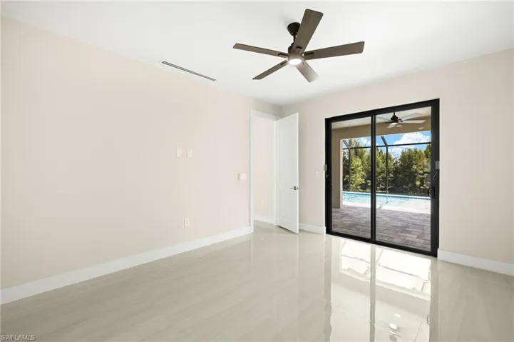 Primary bedroom with sliders opening up to lanai/pool area.