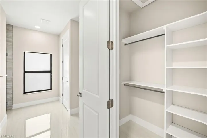 Primary bedroom closet with built in shelving (1)