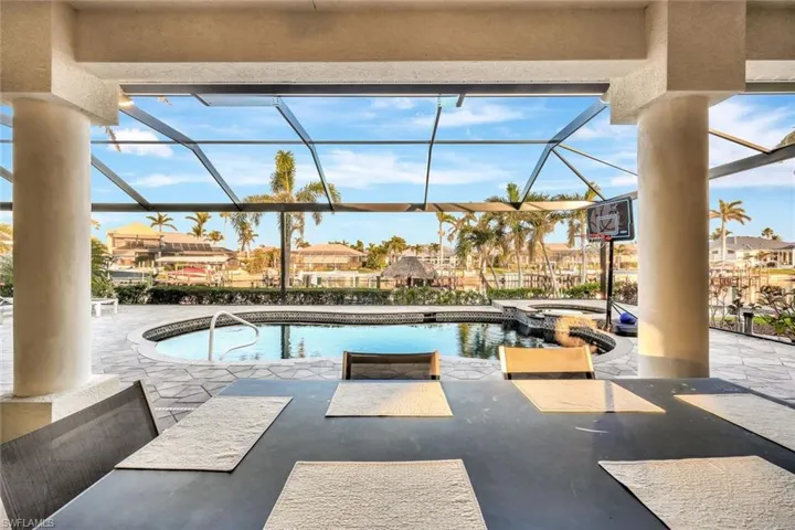 View of swimming pool featuring a lanai, an in ground hot tub, and a patio