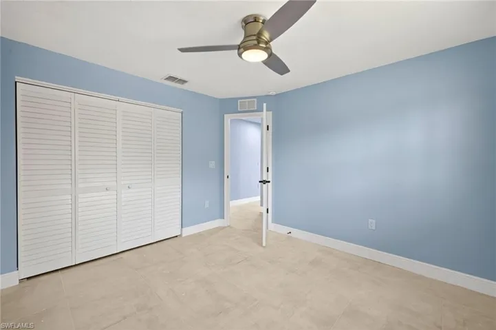 Bedroom #3 featuring tile flooring and light blue walls