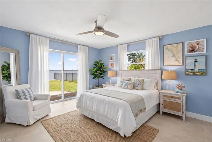 Virtually Staged...Bedroom #2 featuring sliding glass doors opening to a waterfront expanse