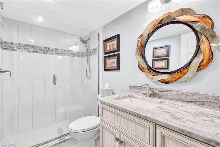 Full bath with vanity and a shower stall