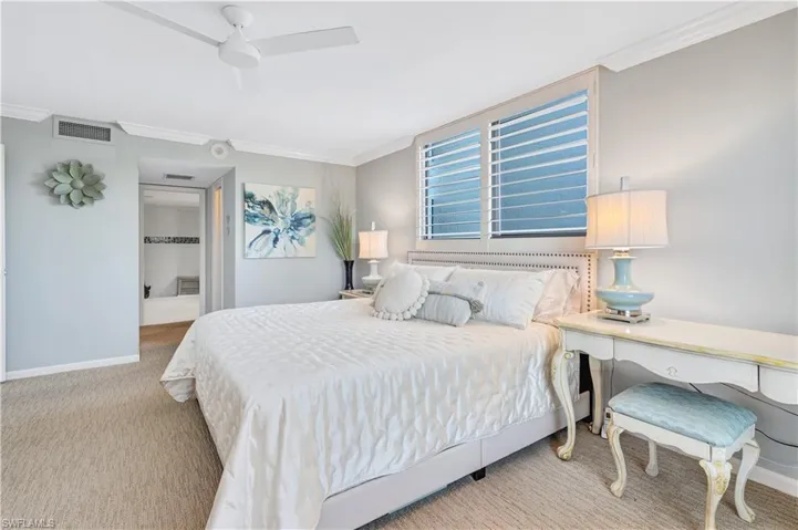Primary bedroom with crown molding and ceiling fan