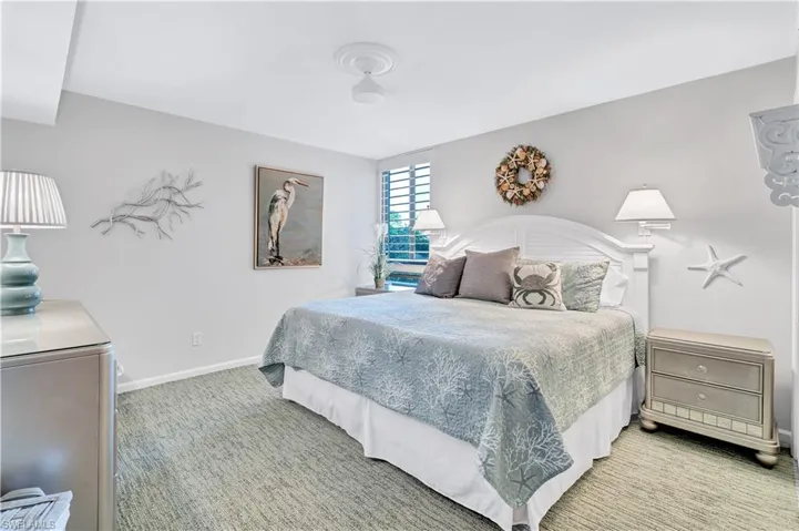 Guest Bedroom with light carpet and baseboards